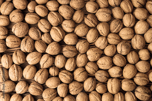 Walnuts background. Walnuts texture. Group walnuts on wooden bac