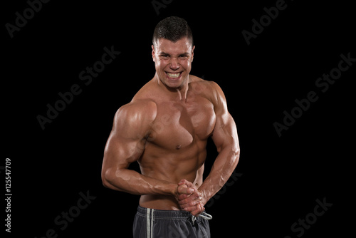 Muscular Men Flexing Muscles On Black Background