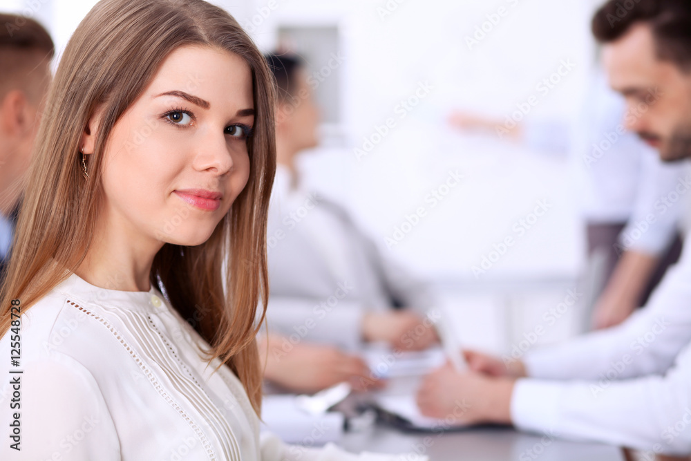Portrait of a young business woman at meeting. Portrait of a young business woman at meeting.
