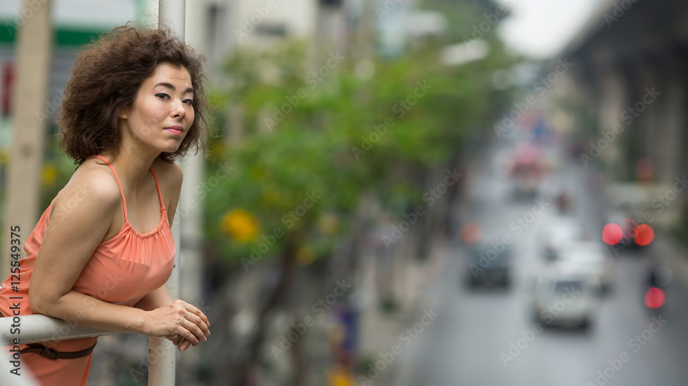 Beautiful asian woman in a blurred urban landscape.