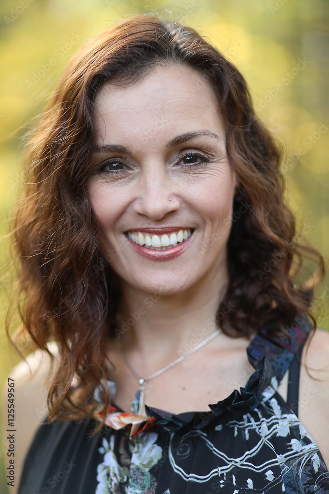 Woman with Brown Hair Against a Fall Background