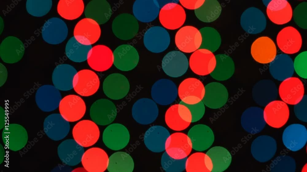 Abstract defocused colorful blinking lights. Christmas and New Year garland on a black background. Abstract defocused colorful blinking lights. Christmas and New Year garland on a black background.