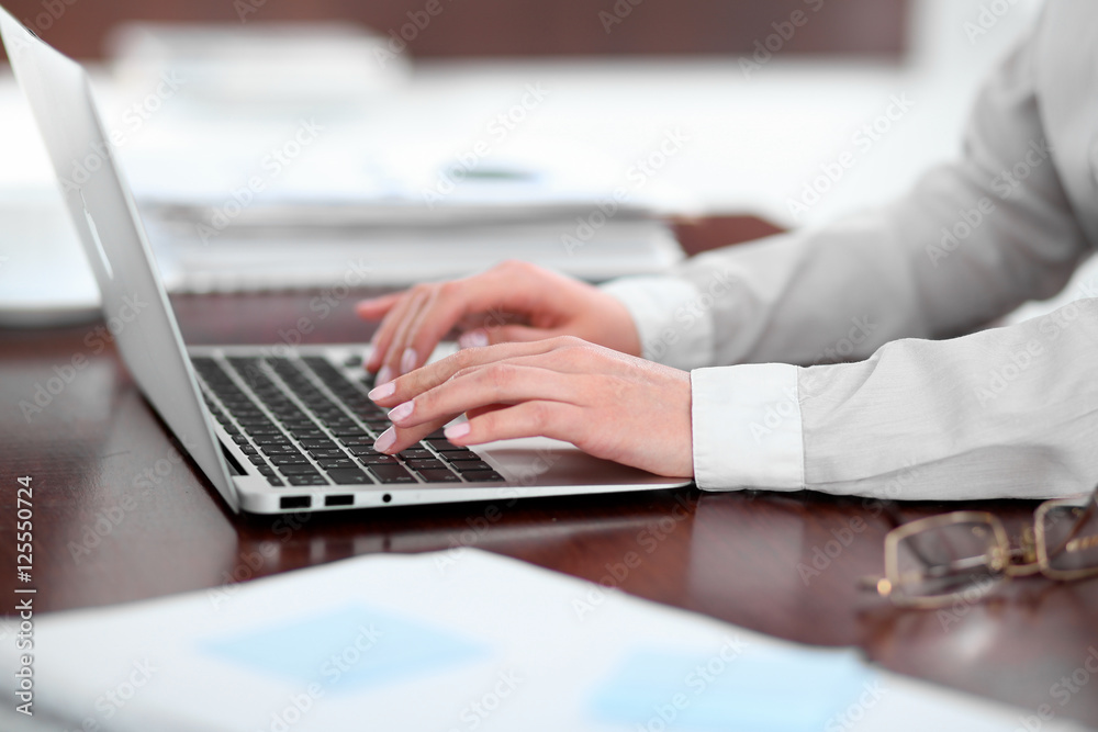 Close up of business woman hands typing on laptop computer Close up of business woman hands typing on laptop computer