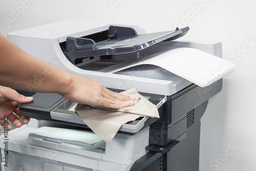 close up man clean the printer touchscreen