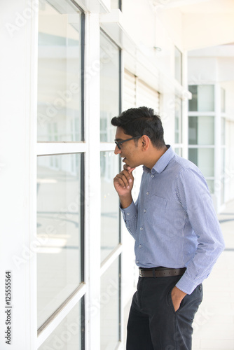 Male real estate agent looking up at a house exterior
