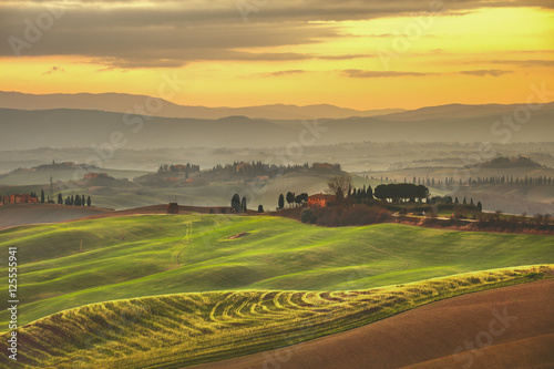 Obraz na płótnie Tuscany spring, rolling hills on misty sunset. Rural landscape. w salonie
