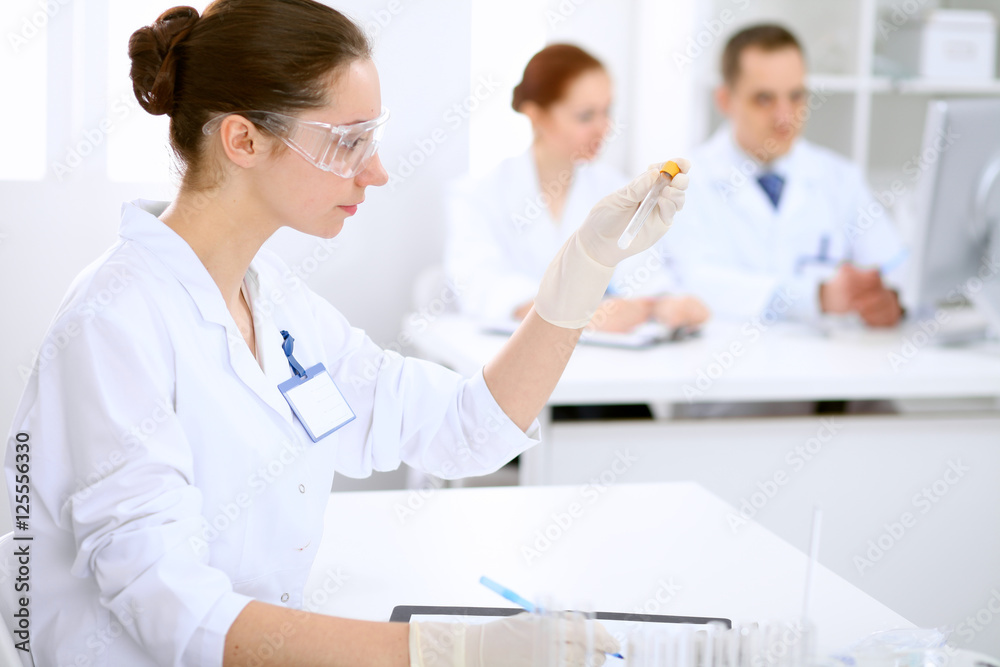 Scientific research team with clear solution in laboratory Scientific research team with clear solution in laboratory
