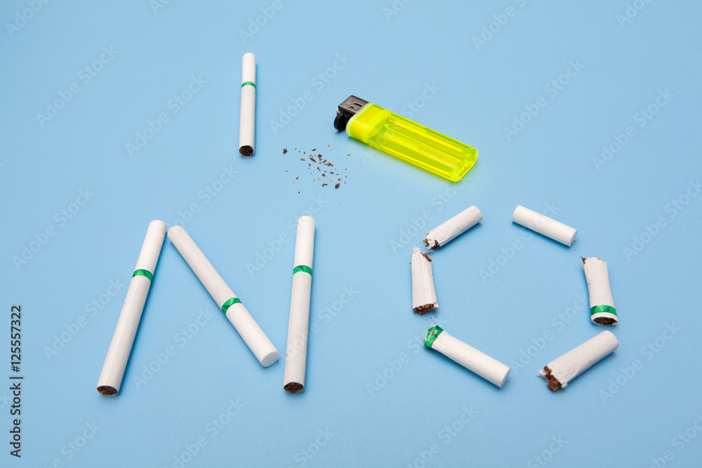 no smoking concept, text made by cigarette on blue backgrounds no smoking concept, text made by cigarette on blue backgrounds