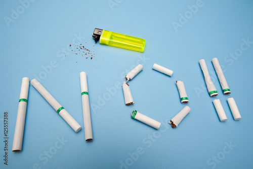 no smoking concept, text made by cigarette on blue backgrounds