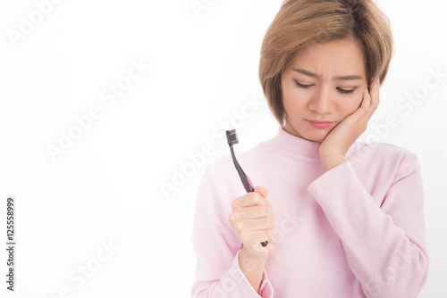 Asian woman toothache holding Toothbrush on white background.