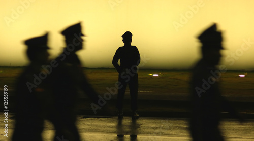 Black silhouette on wall background of a uniformed police officer, Style photo blur