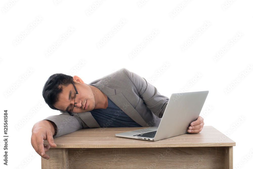 Businessman sleeping next to his laptop computer with white back Businessman sleeping next to his laptop computer with white back