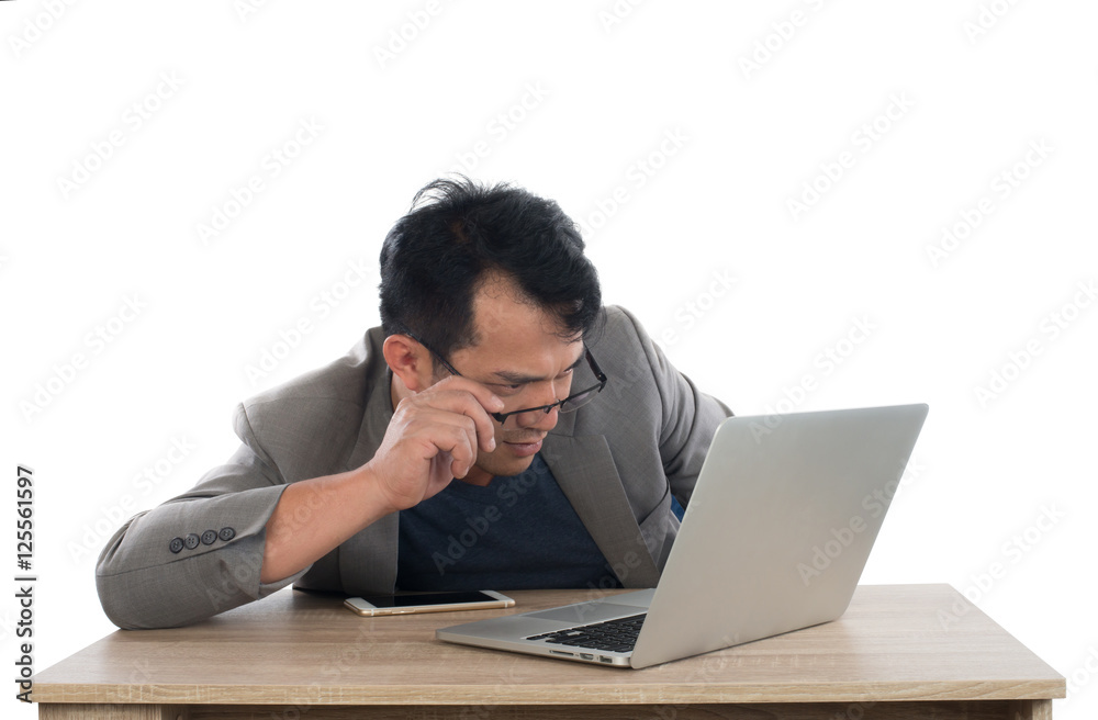 Stressed businessman work with laptop sitting at table isolated Stressed businessman work with laptop sitting at table isolated