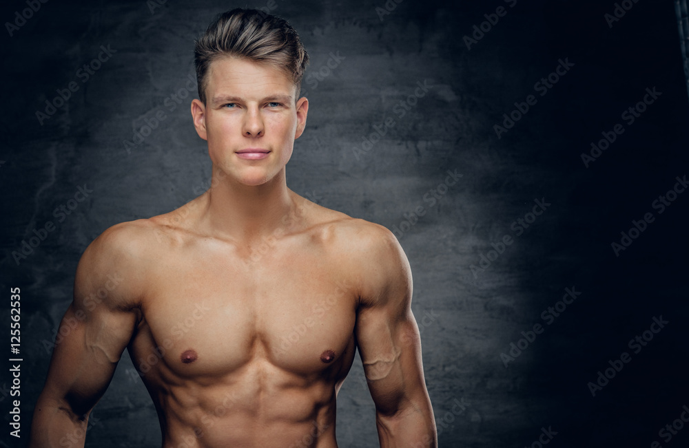 Fototapeta premium Shirtless sporty male on grey background.