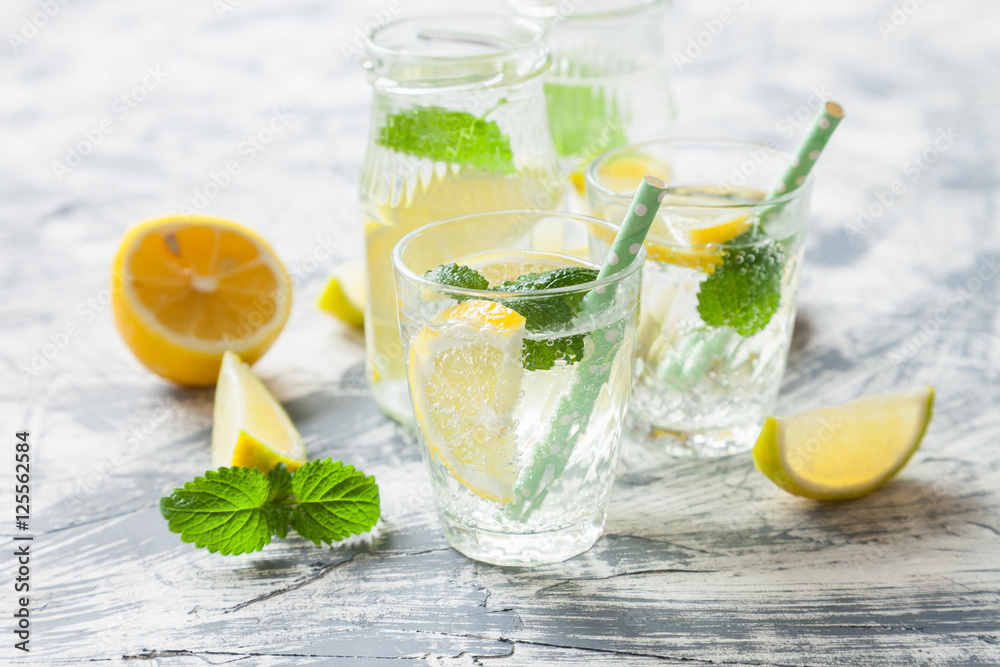 fresh citrus lemonade with mint in a glass on a concrete background, selective focus fresh citrus lemonade with mint in a glass on a concrete background, selective focus