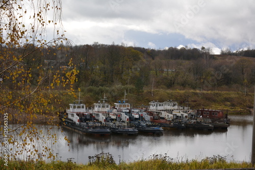 ships, barges in the river port in autumn industrial landscape photo