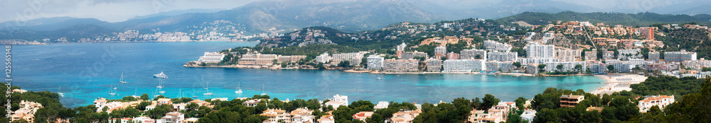 Beautiful panoramic view from above of Santa Ponsa resort, the beach with white sand, sunbeds, hotels and yachts, Majorca