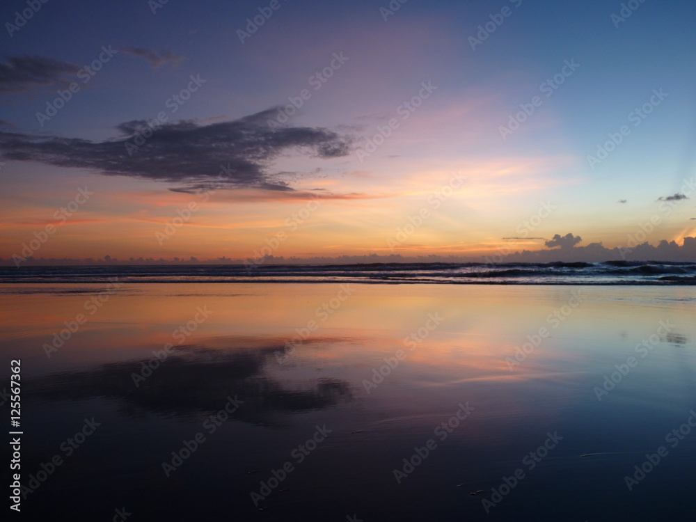 Beautiful sunset on the tropical sandy beach in Bali. Indonesia