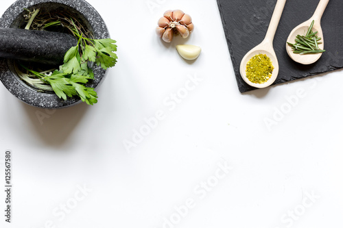 spices for cooking with pounder on white background top view