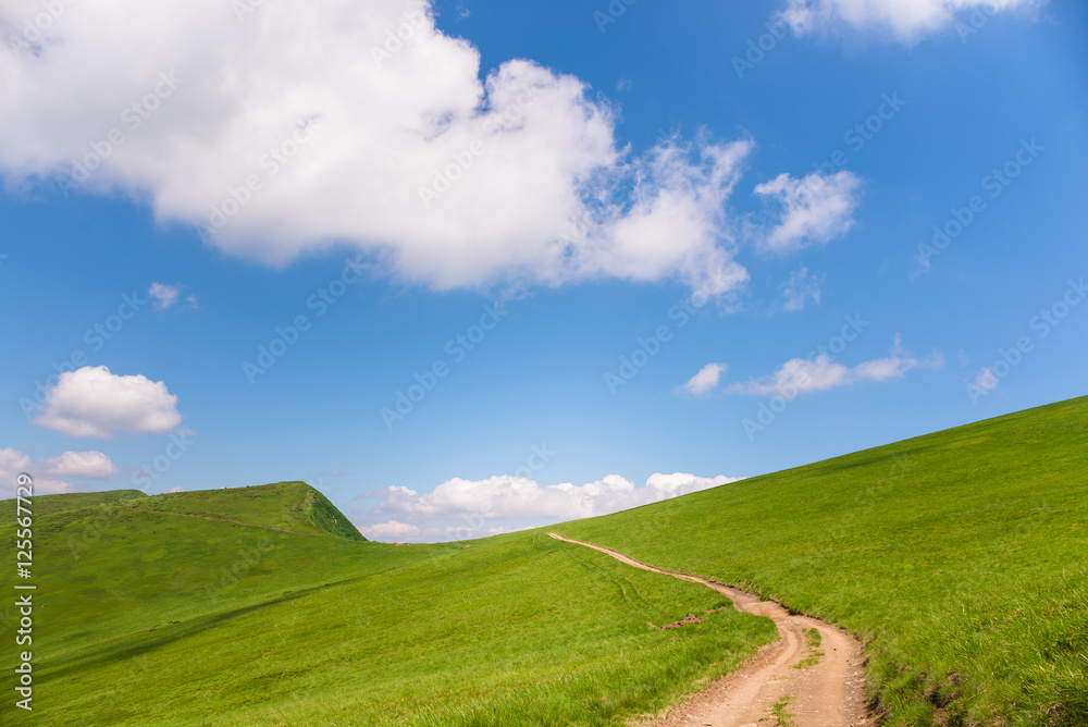 idyllic landscape of green heels, blue sky in Carpathian mountains