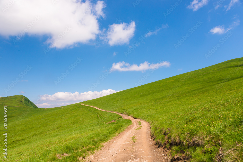 idyllic landscape of green heels, blue sky in Carpathian mountains