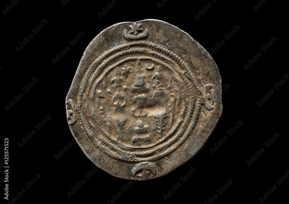 Ancient silver Sassanian coin isolated on black