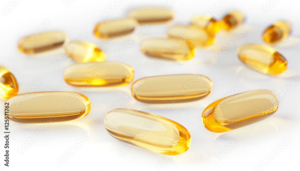 Cod liver oil capsules on white background Cod liver oil capsules on white background