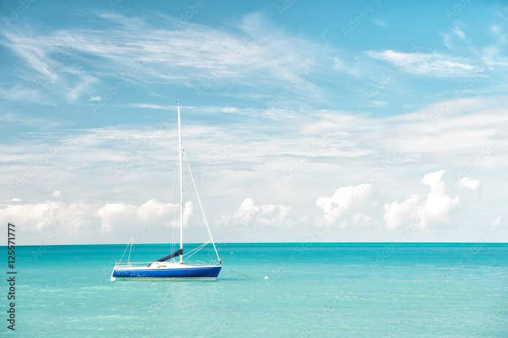 Attractive bright view of exotic colorful beautiful marine beach with boat on blue water