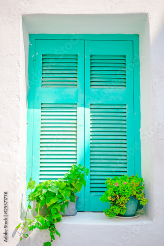 Traditional colorful window in the narrow streets of Mykonos, Greece.