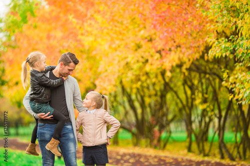 Family having fun on autumn day. Dad and kids enjoy fall © travnikovstudio