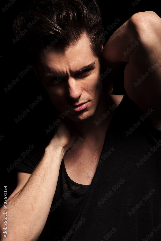 sexy fashion man posing with hands behind neck
