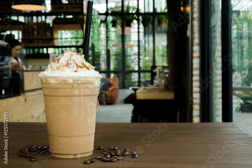 Iced coffee with whipped cream and sprinkle with almonds photo