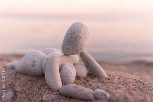 Figurine of pebbles on seashore