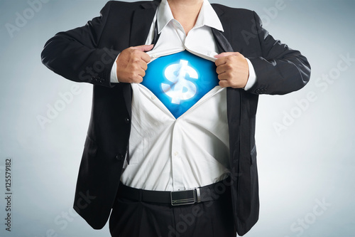 Image of young businessman in superhero suit with dollar sign on chest