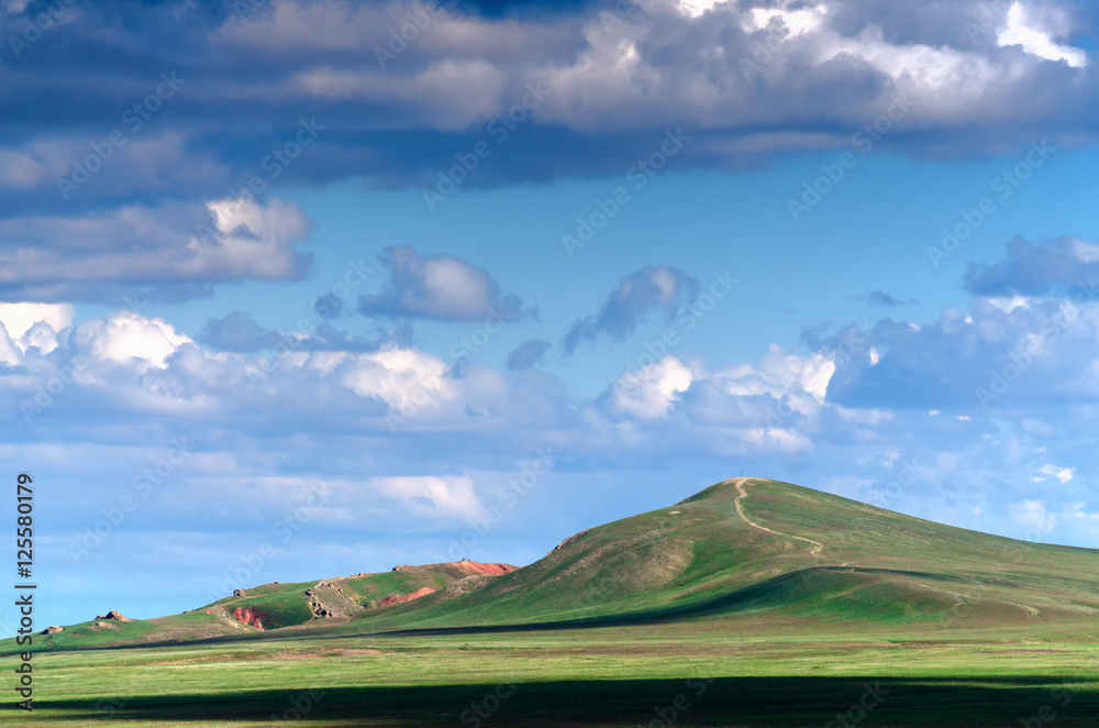 Bogdo mountain under beautiful sky. Panorama of steppe near salt lake Baskunchak