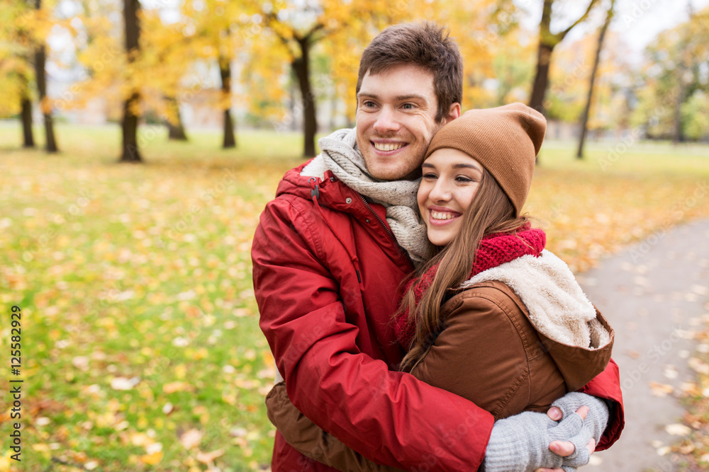 Fototapeta premium happy young couple hugging in autumn park