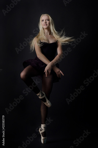 Beautiful graceful blond dancer in bright satin pointe.