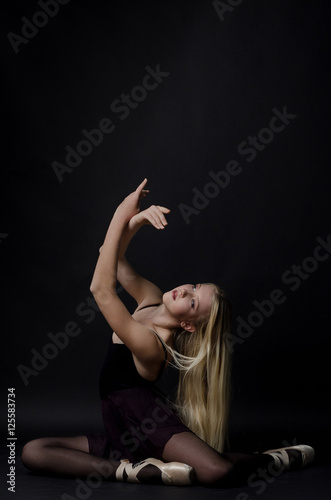 Beautiful graceful blond dancer in bright satin pointe.