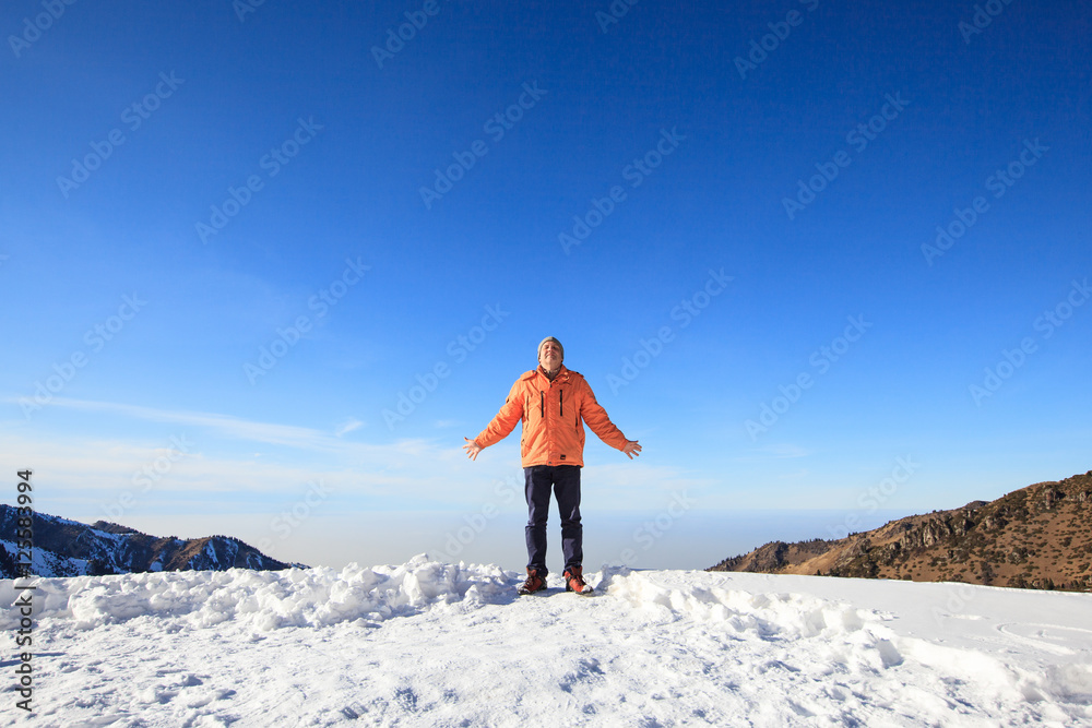 Happy men standing on the top of mountain. Winter travel concept 
