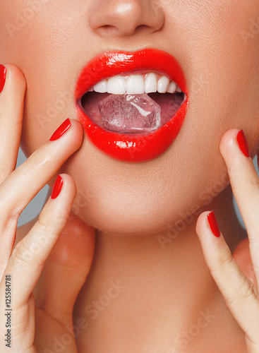 Close-up shot of woman's lips with ice cube

