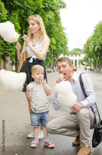 Young family is eating cotton candy