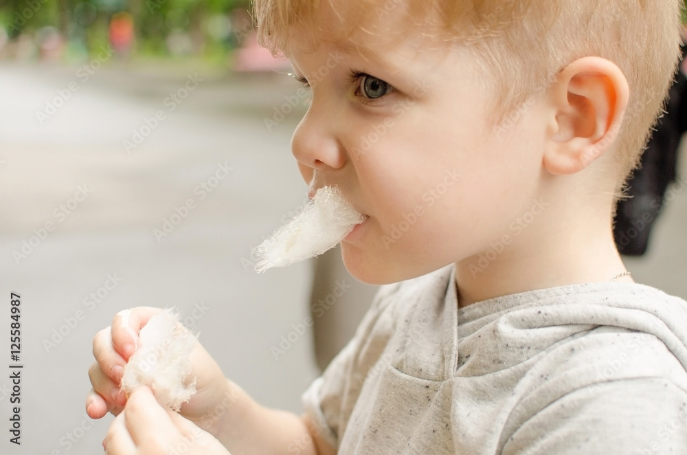 Small baby boy is eating cotton candy Small baby boy is eating cotton candy