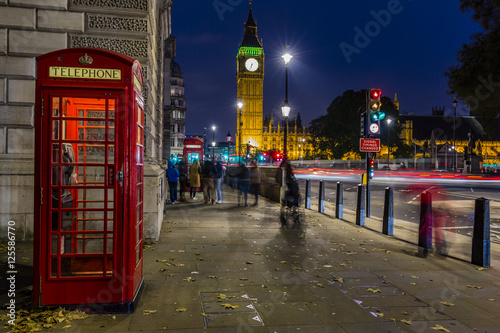 Famous English red telephone boxes with Big Ben in London at nig