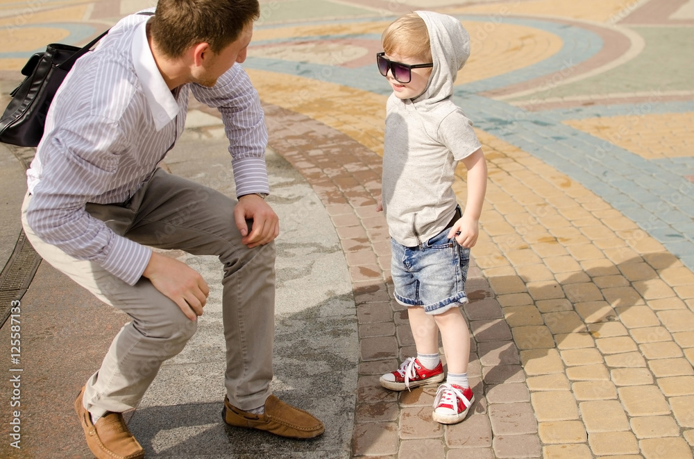 baby boy is walking in the park with his father baby boy is walking in the park with his father