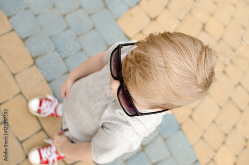 Small baby boy is faving fun in the park photo