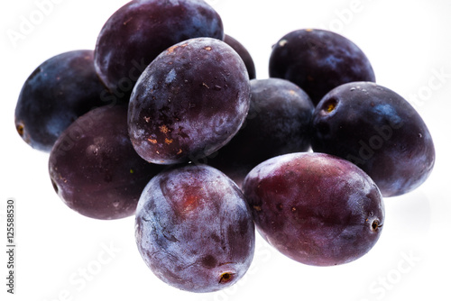 Homegrown organic pile of blue plums isolated on white backgroun