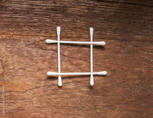 square cotton bud on wood table