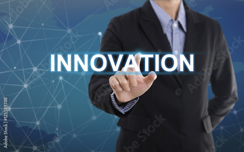 Businessman hand pressing button innovation. sign on virtual screen. business concept.