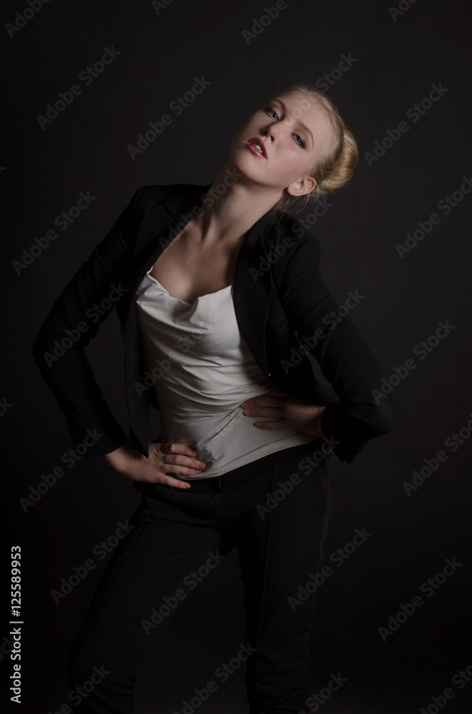 Beautiful blonde woman in a severe  business suit