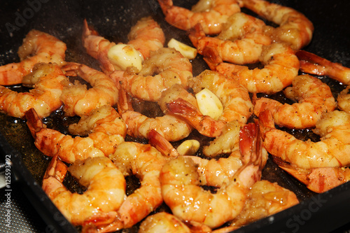 Shrimps with garlic and spices on a grill